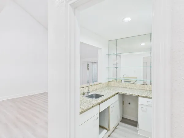a view of a kitchen with a sink and cabinets