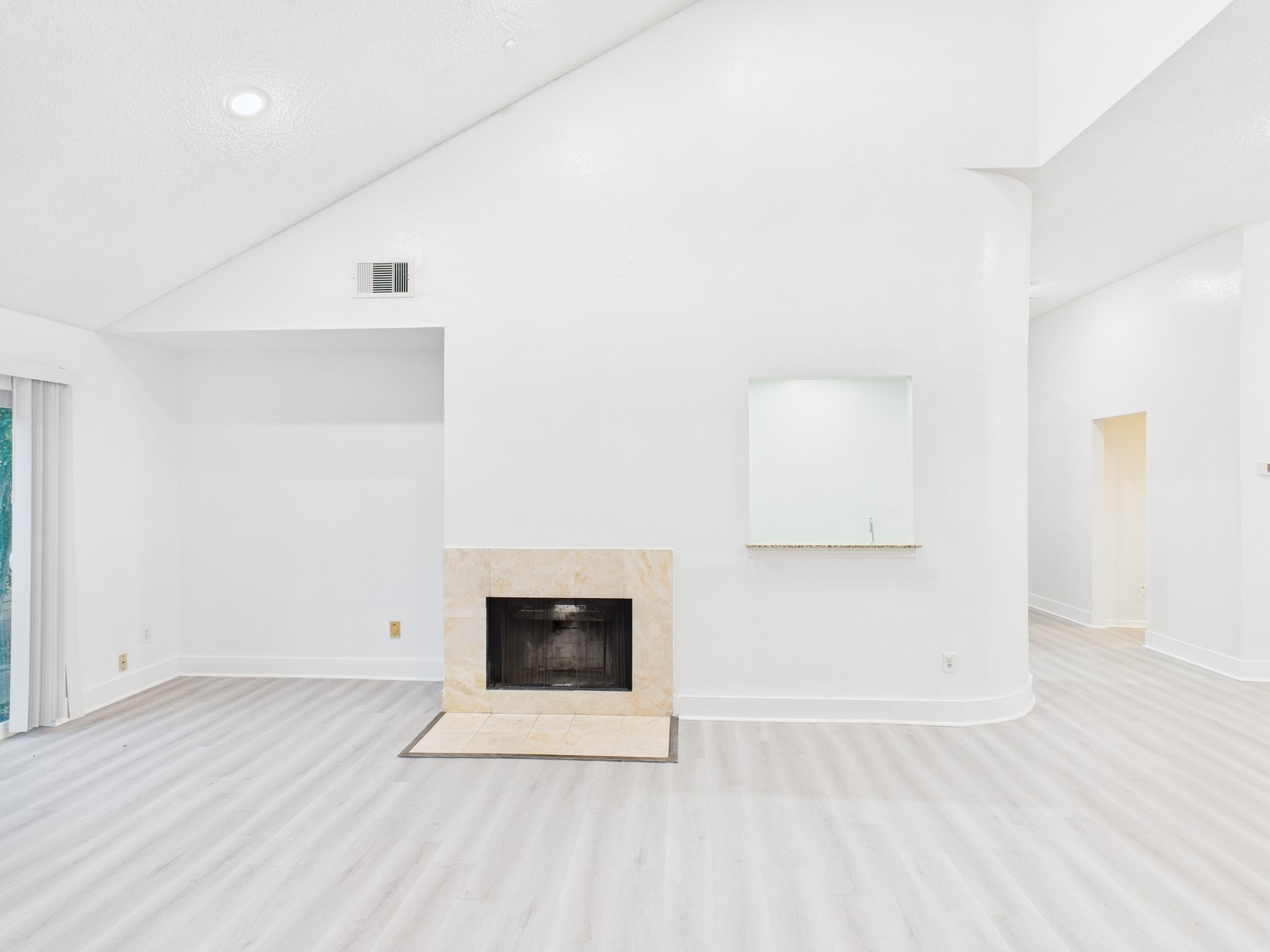 7610 Hopewell Lane Houston, TX 77071 - Photo 13 of 31 an empty room with wooden floor and a fireplace