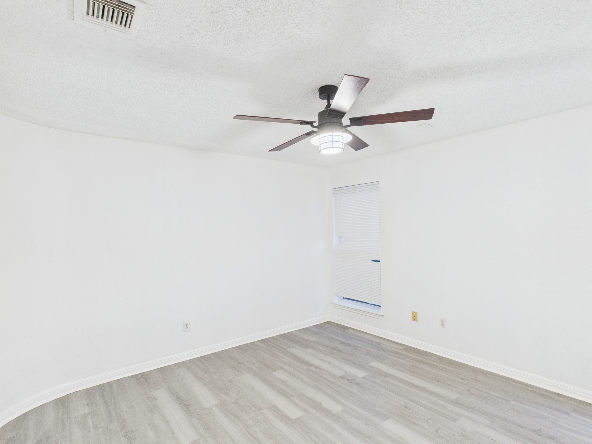 7610 Hopewell Lane Houston, TX 77071 - Photo 16 of 31 a view of a room with wooden floor and a ceiling fan