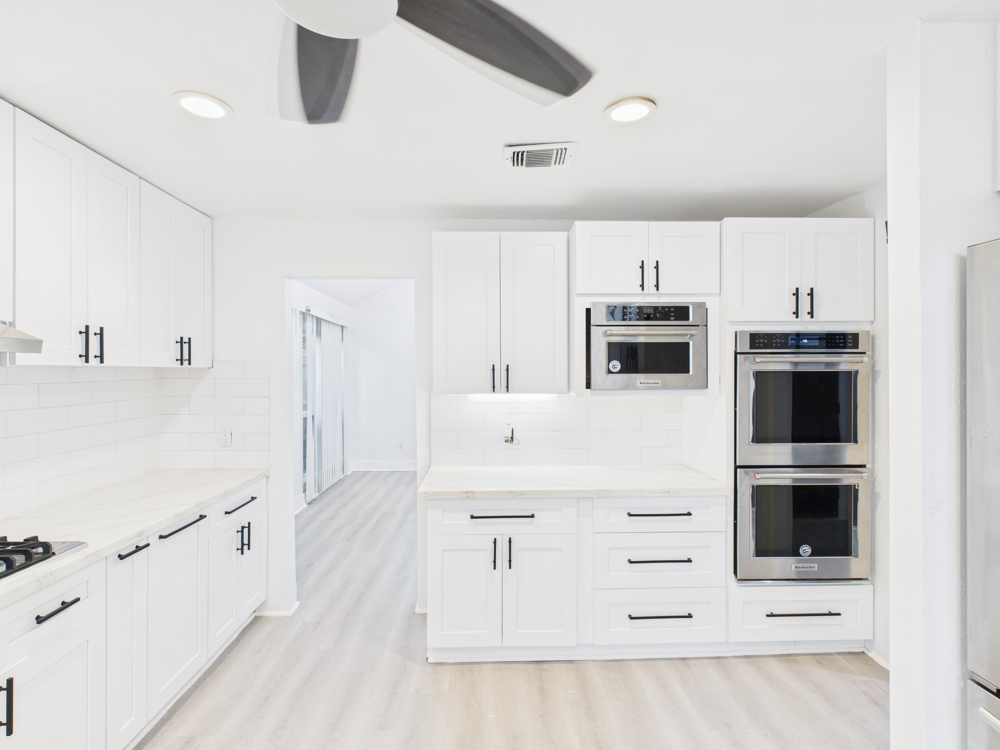 7610 Hopewell Lane Houston, TX 77071 - Photo 5 of 31 a kitchen with stainless steel appliances a refrigerator and white cabinets