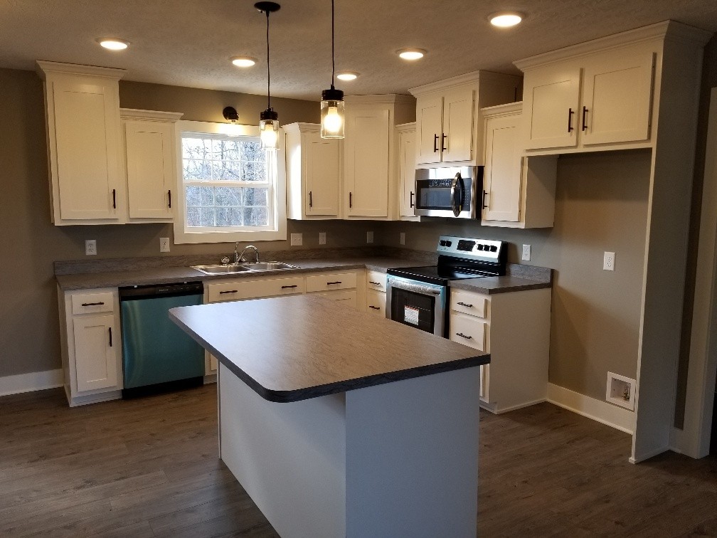 210 Hog Back Ridge Road Bethpage, TN 37022 - Photo 3 of 13 a kitchen that has a sink a stove top oven a counter space and cabinets