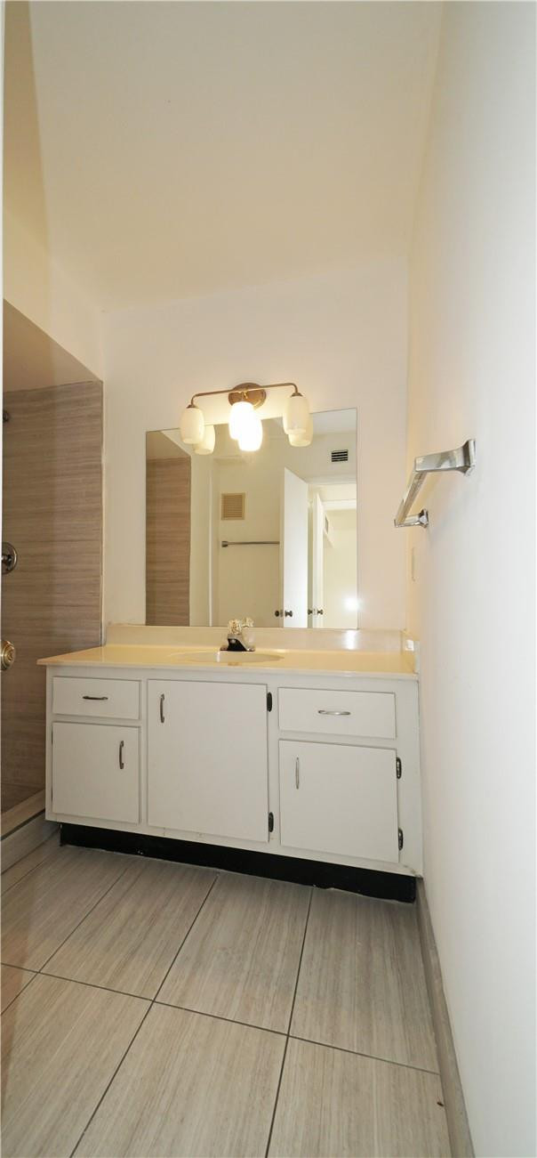 16400 Golf Club Road, Unit 305 Weston, FL 33326 - Photo 11 of 24 a bathroom with a double vanity sink a mirror and a bathtub