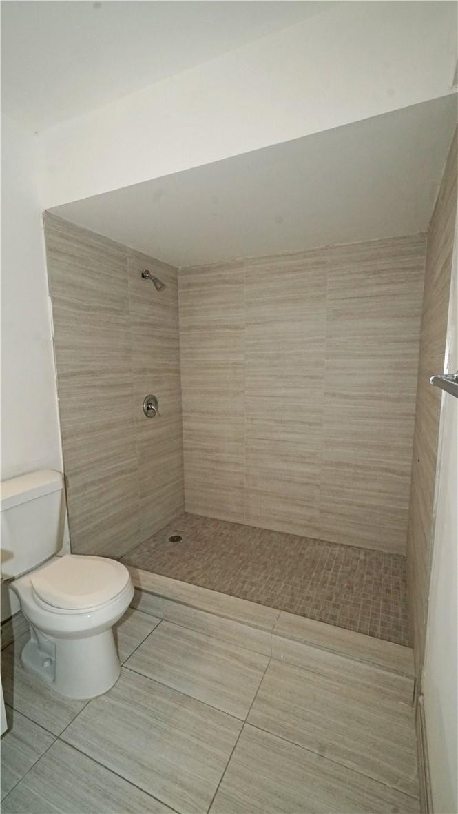 16400 Golf Club Road, Unit 305 Weston, FL 33326 - Photo 14 of 24 a bathroom with a toilet and a shower