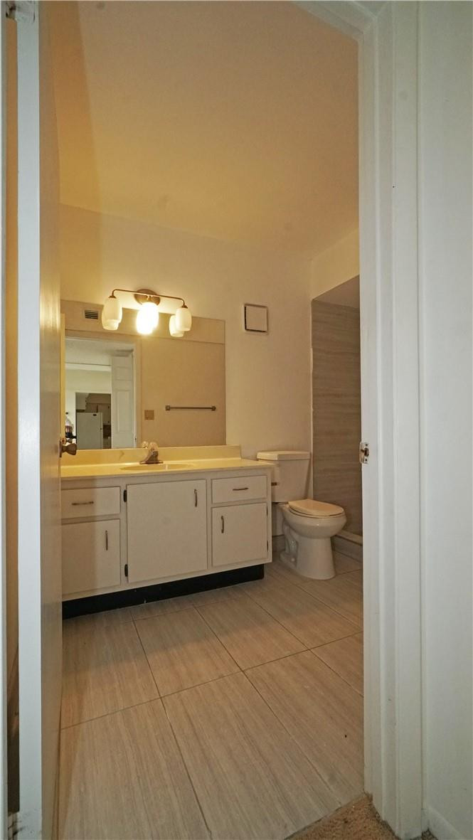 16400 Golf Club Road, Unit 305 Weston, FL 33326 - Photo 15 of 24 a bathroom with a double vanity sink a toilet and a tub