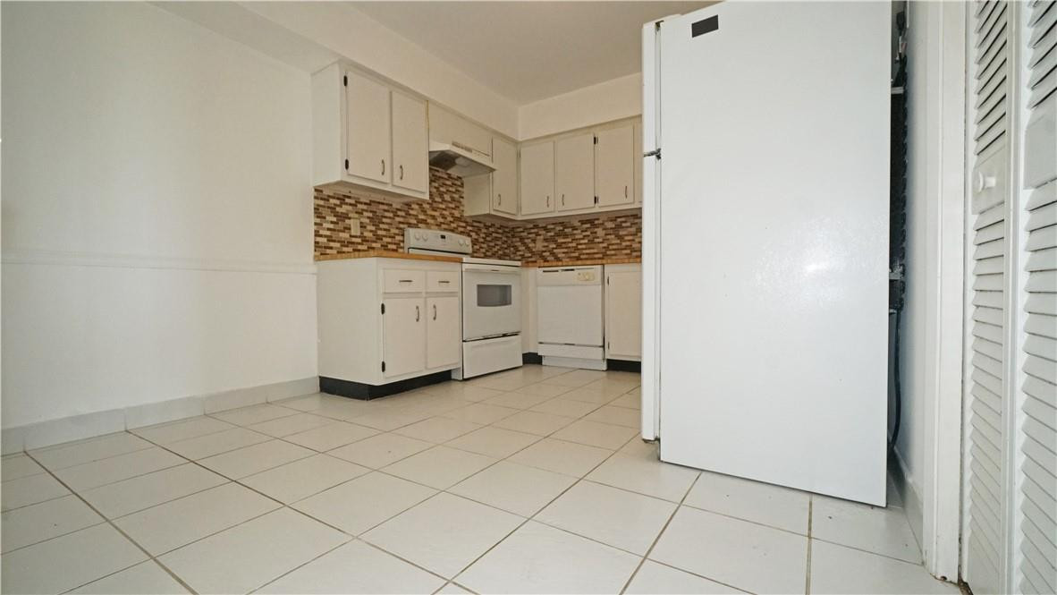 16400 Golf Club Road, Unit 305 Weston, FL 33326 - Photo 20 of 24 a utility room with cabinets washer and dryer
