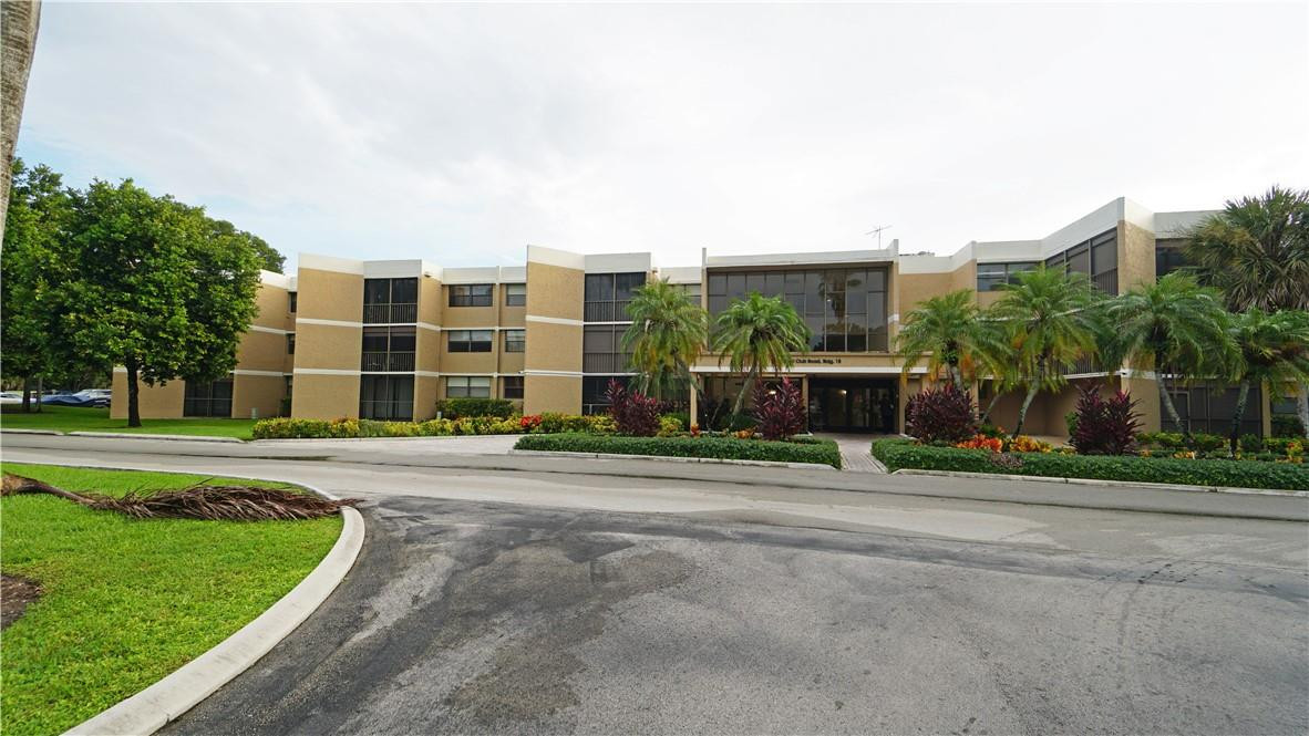 16400 Golf Club Road, Unit 305 Weston, FL 33326 - Photo 2 of 24 a front view of a house with a yard