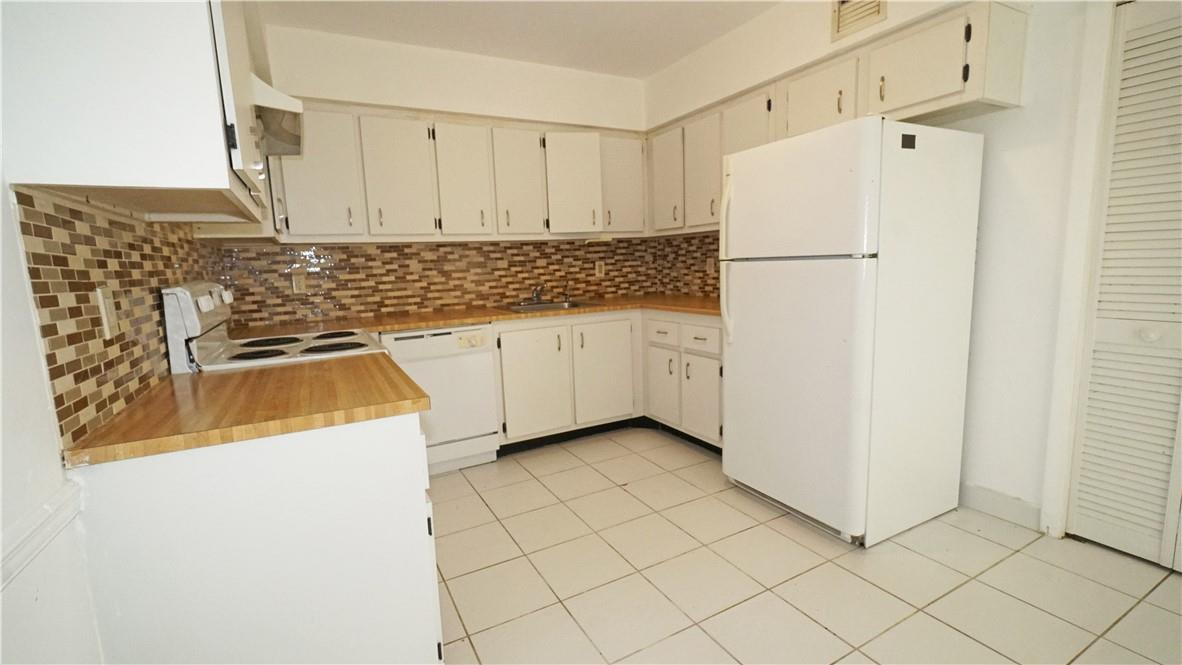 16400 Golf Club Road, Unit 305 Weston, FL 33326 - Photo 21 of 24 a white refrigerator freezer sitting inside of a kitchen