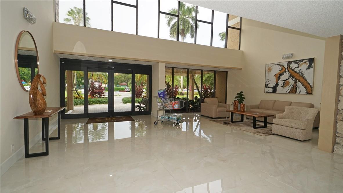 16400 Golf Club Road, Unit 305 Weston, FL 33326 - Photo 3 of 24 a living room with furniture and a large window