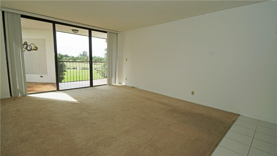 16400 Golf Club Road, Unit 305 Weston, FL 33326 - Photo 4 of 24 a view of an empty room with sliding glass door
