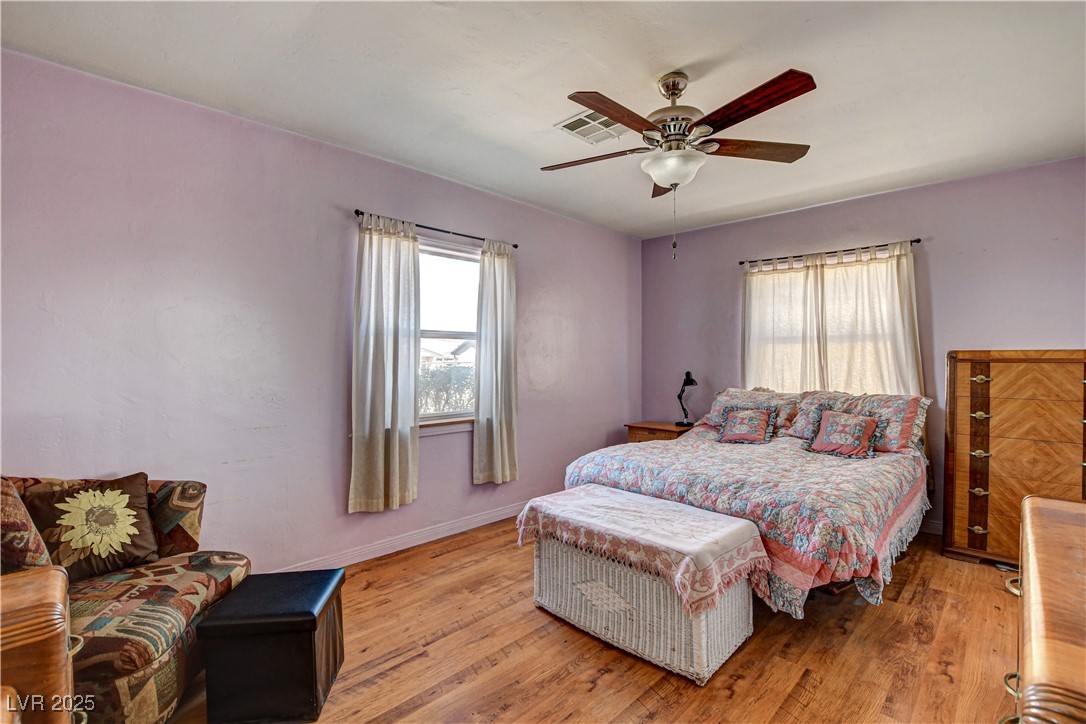 239 West Basic Road Henderson, NV 89015 - Photo 24 of 43 Bedroom with light wood finished floors, visible vents, baseboards, and ceiling fan