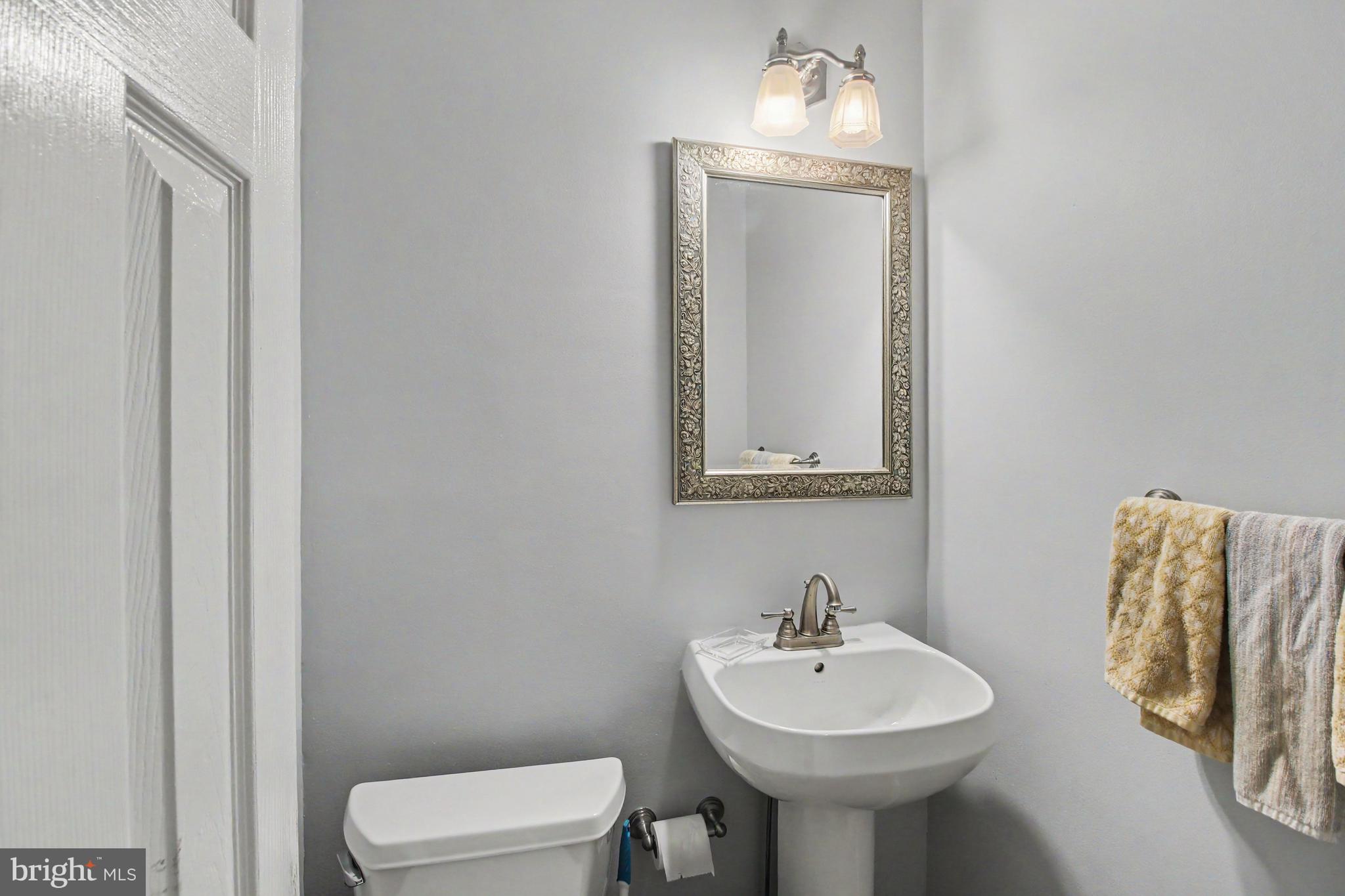 917 Cedar Grove Road Broomall, PA 19008 - Photo 16 of 33 a bathroom with a toilet sink and mirror