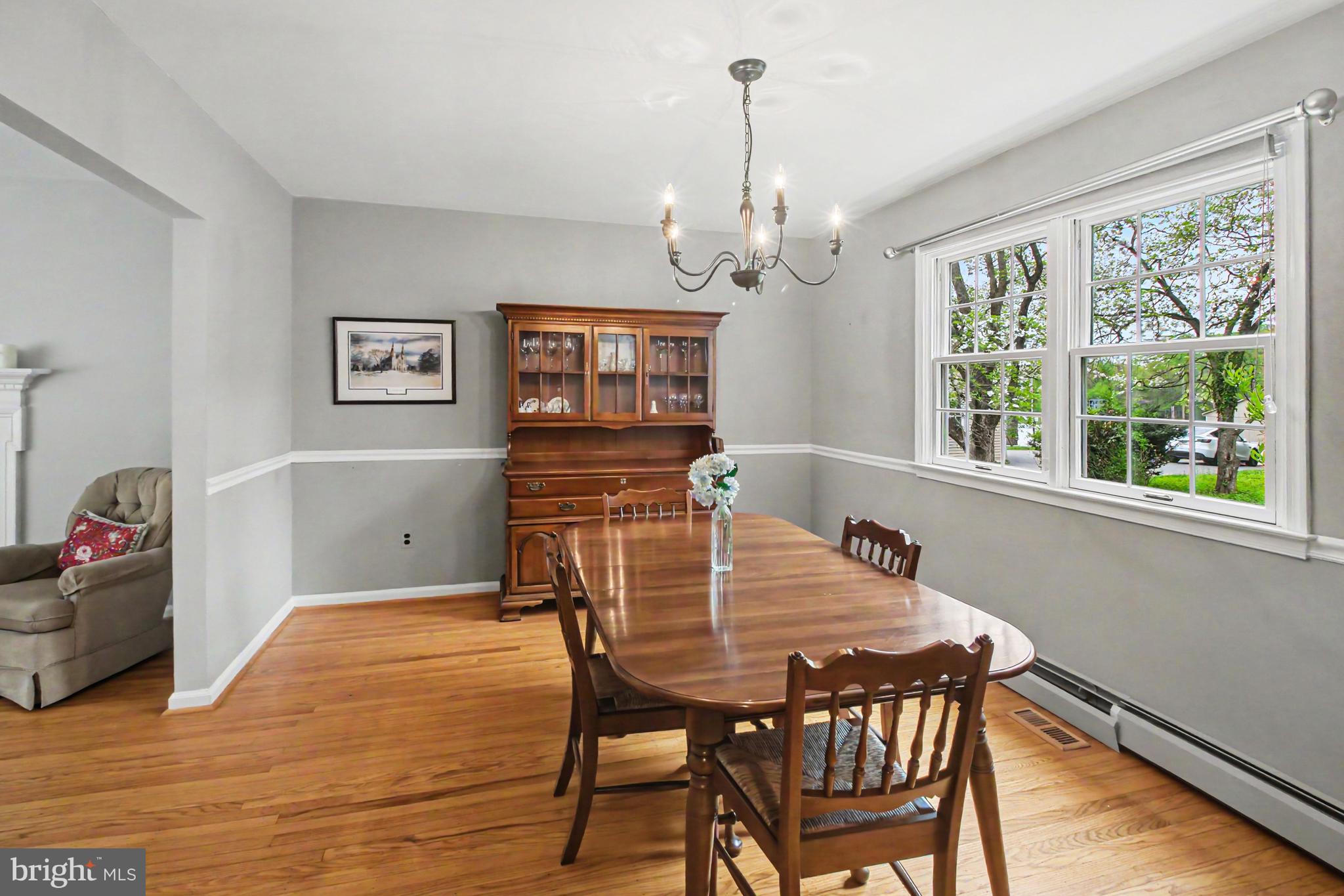 917 Cedar Grove Road Broomall, PA 19008 - Photo 8 of 33 a view of a dining room with furniture a chandelier and wooden floor