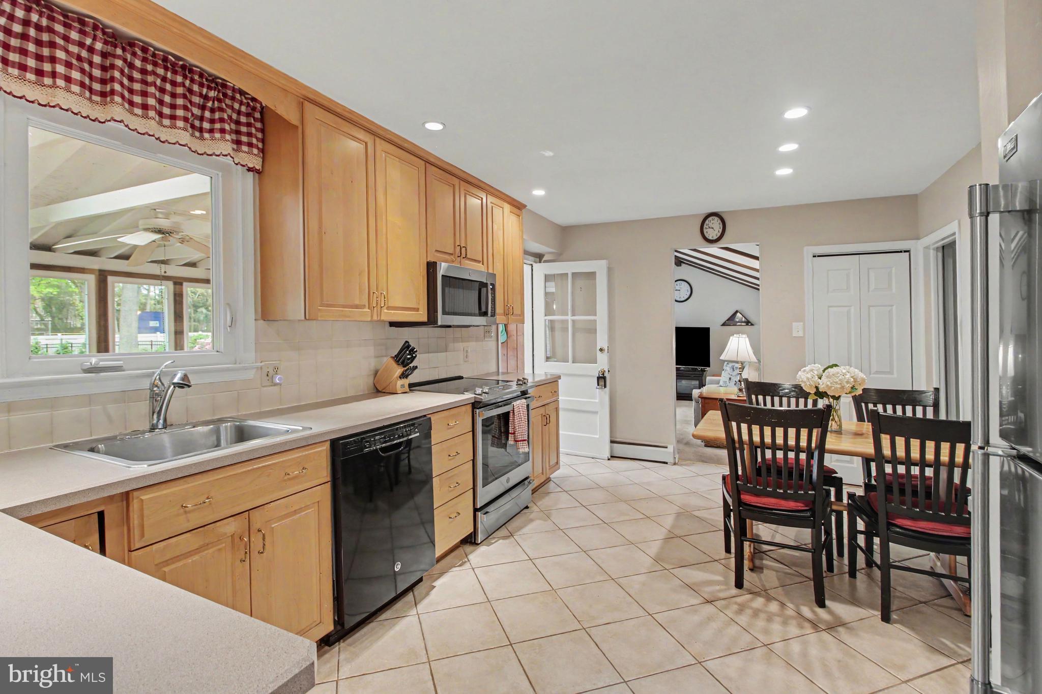 917 Cedar Grove Road Broomall, PA 19008 - Photo 10 of 33 a kitchen with table chairs sink and cabinets
