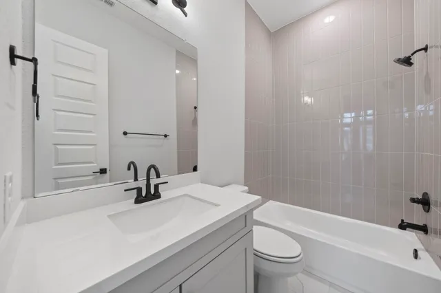 an empty room with wooden floor and ceiling fan