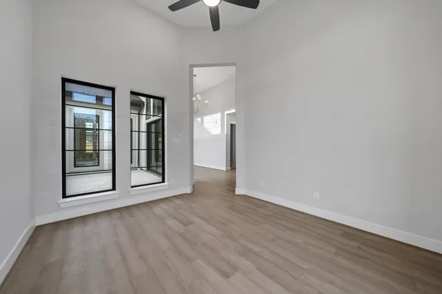 wooden floor in an empty room with a window
