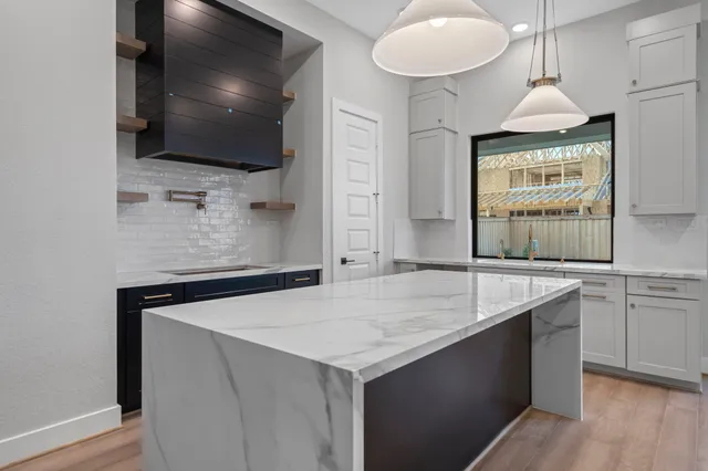 a view of a hallway with wooden floor and a fireplace