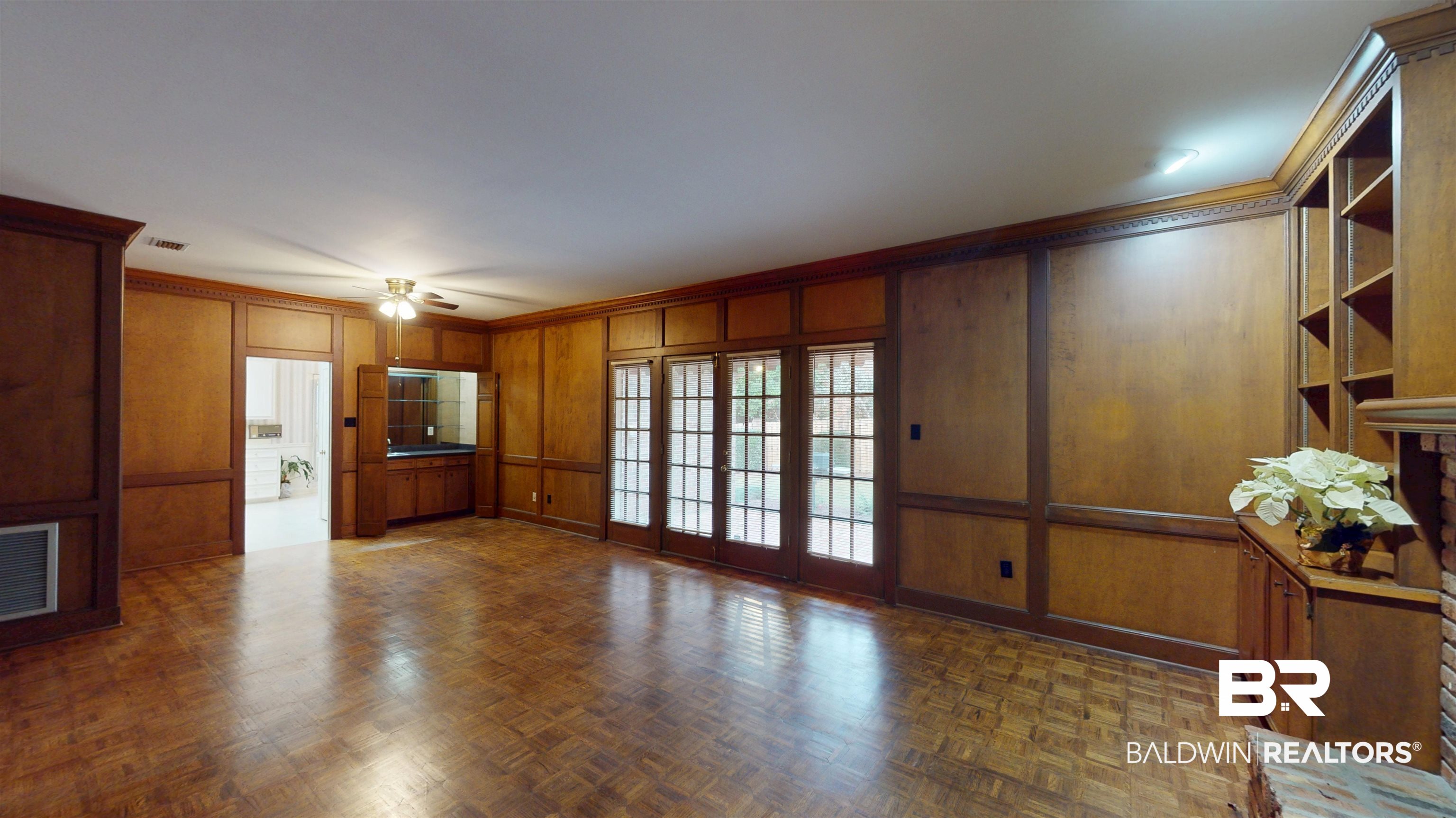 53 Warwick Road Mobile, AL 36608 - Photo 25 of 45 Den featuring ceiling fan, a decorative wall, ornamental molding, and wooden walls