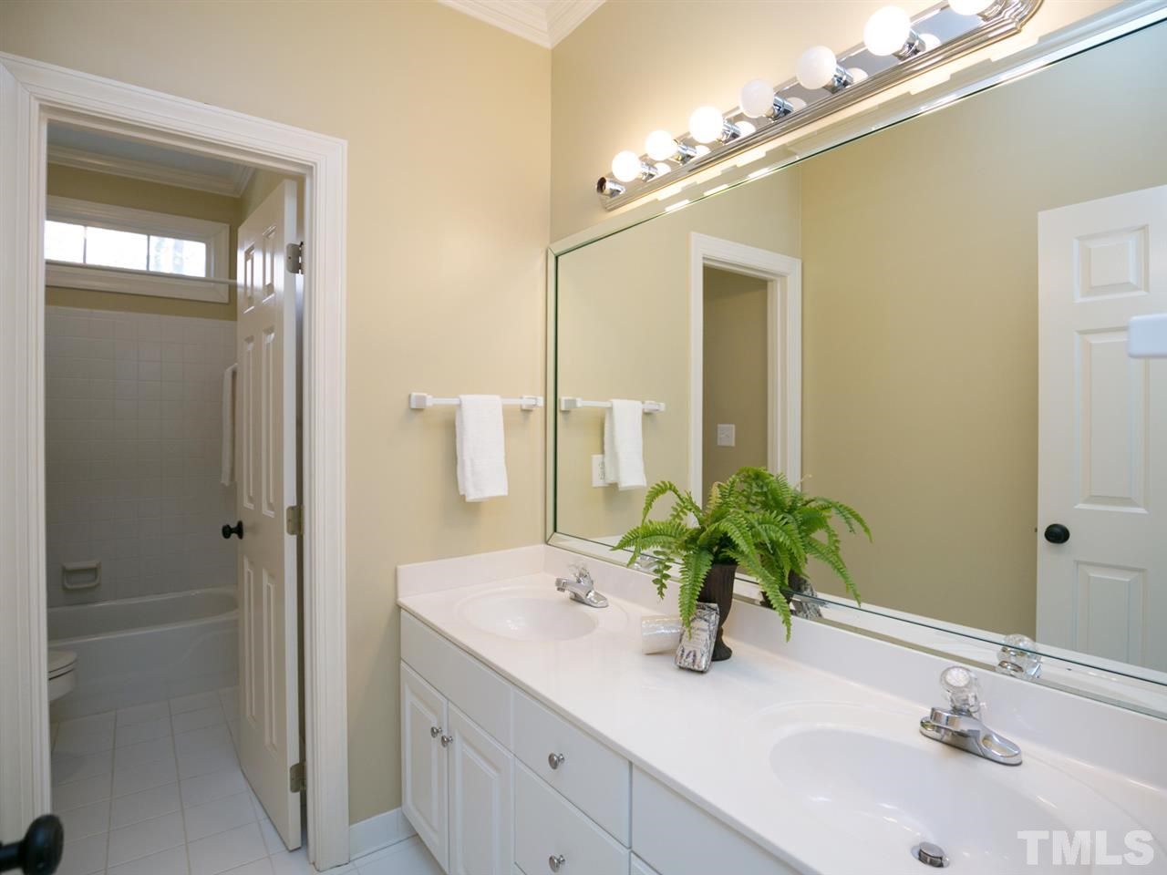 7909 Ridge Pointe Lane Raleigh, NC 27615 - Photo 14 of 25 Hall bathroom with dual vanities; drawer bank; and separate shower area