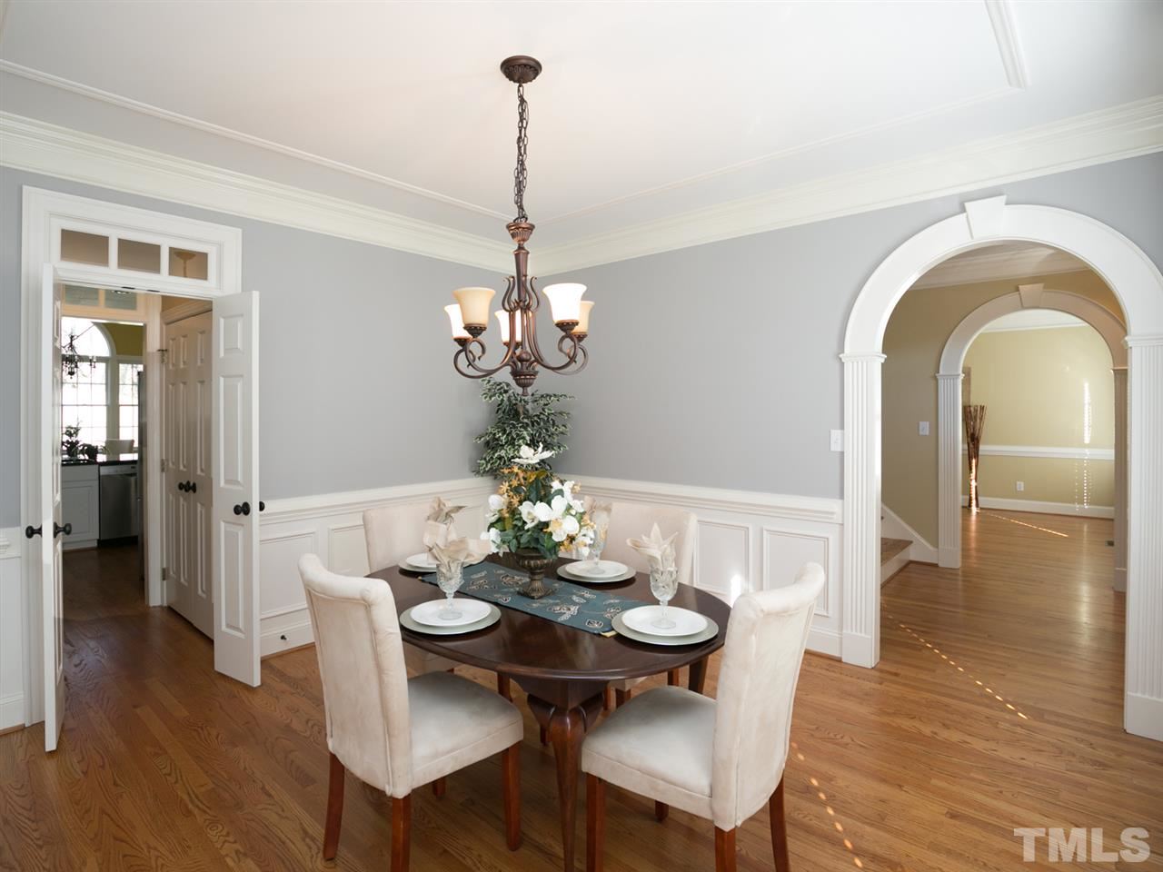 7909 Ridge Pointe Lane Raleigh, NC 27615 - Photo 4 of 25 Archway, shadowboxes, new chandelier, & door with transom