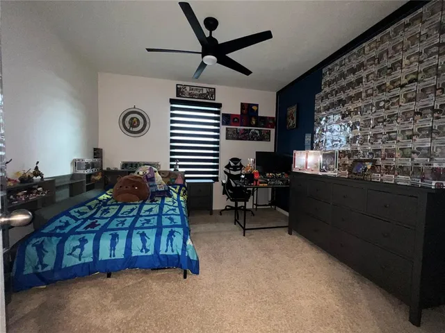 a bedroom with furniture and a large window