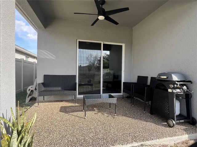 a living room with a flat screen tv and white appliances