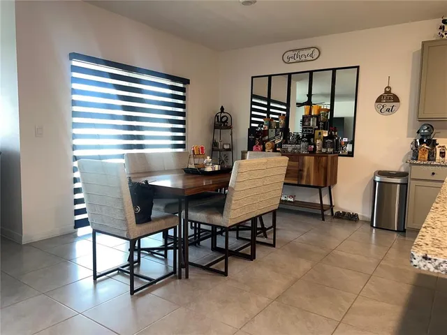 a view of a dining room with furniture and chandelier