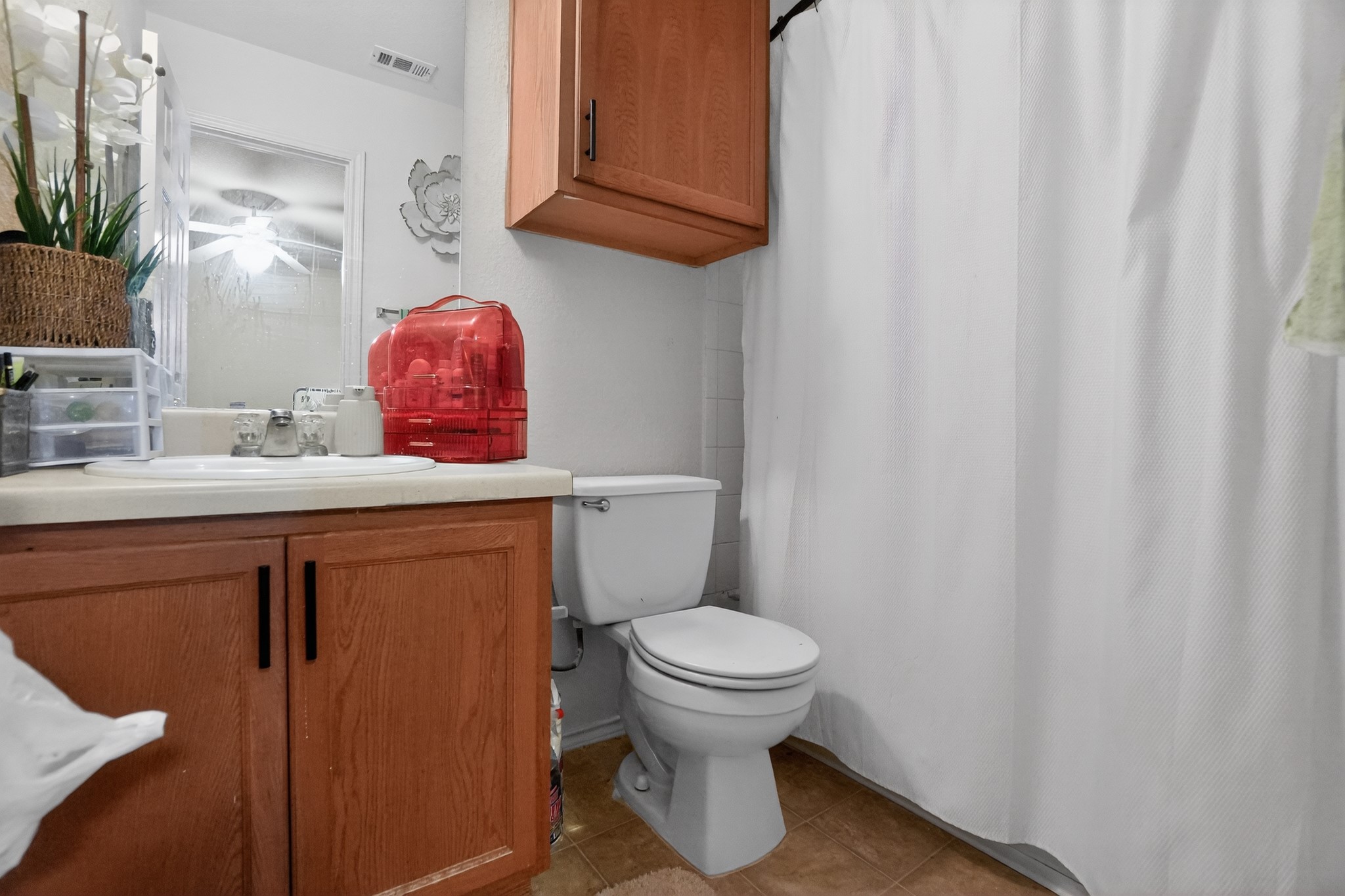 13808 Harris Ridge Boulevard Pflugerville, TX 78660 - Photo 39 of 40 a bathroom with a sink a toilet and a mirror