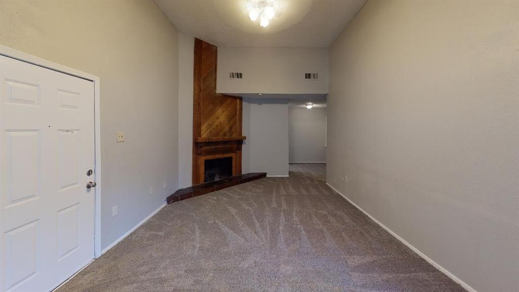 9696 Walnut Street, Unit 2013 Dallas, TX 75243 - Photo 2 of 15 a view of an empty room with a fireplace