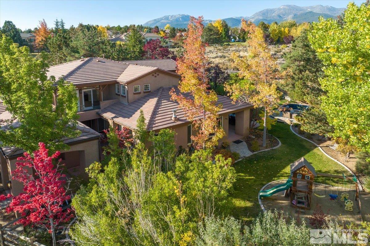 an aerial view of a house with a yard basket ball court and outdoor seating