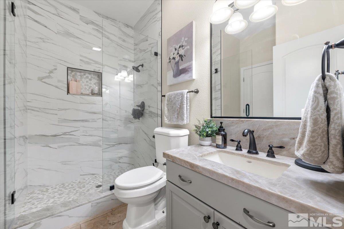 14235 Powder River Court Reno, NV 89511 - Photo 16 of 40 a bathroom with a sink a toilet and shower
