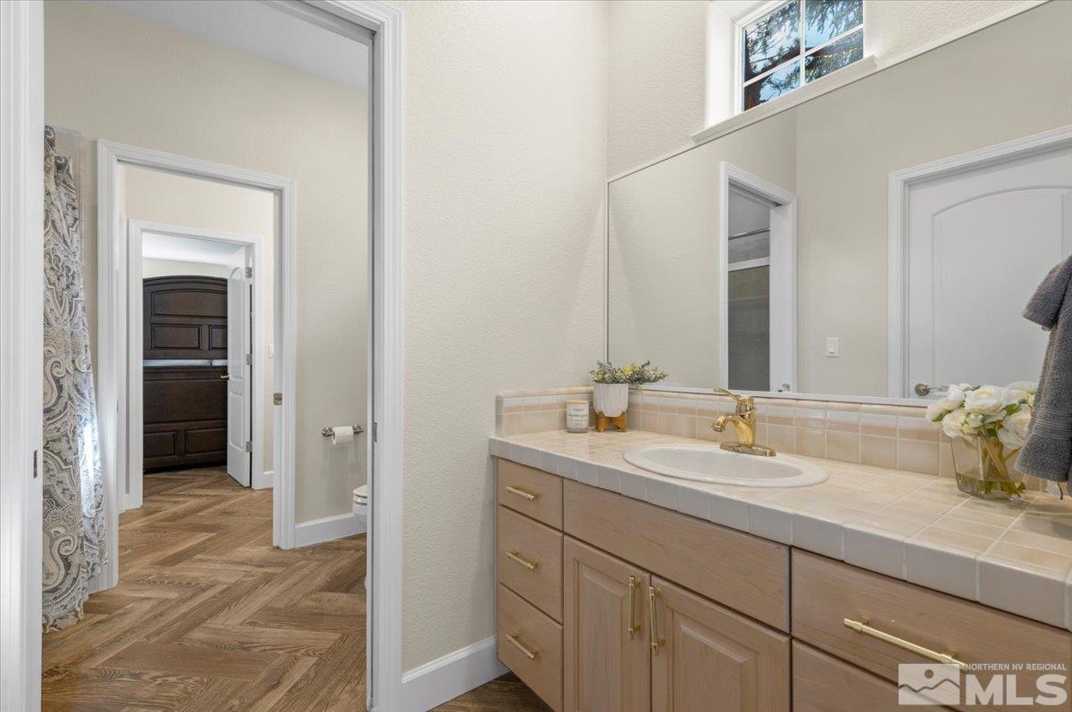 14235 Powder River Court Reno, NV 89511 - Photo 25 of 40 a bathroom with a sink and a mirror