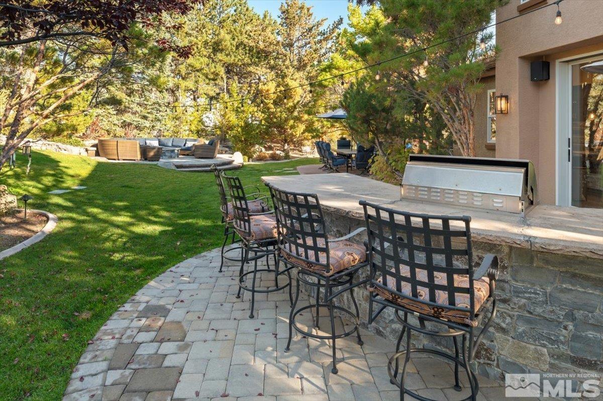 14235 Powder River Court Reno, NV 89511 - Photo 29 of 40 a view of a patio with a table and chairs