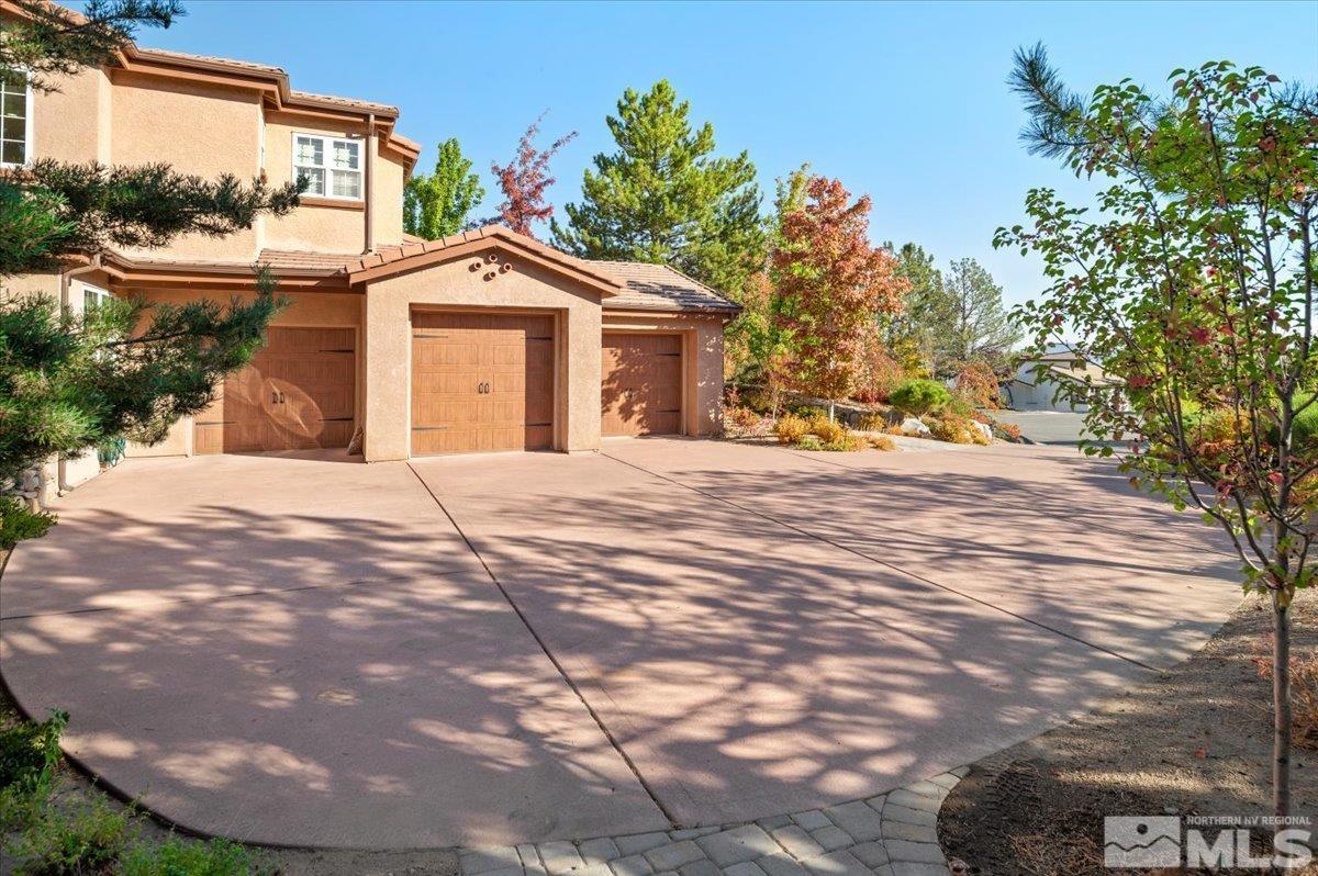 14235 Powder River Court Reno, NV 89511 - Photo 3 of 40 a front view of a house with a yard and garage