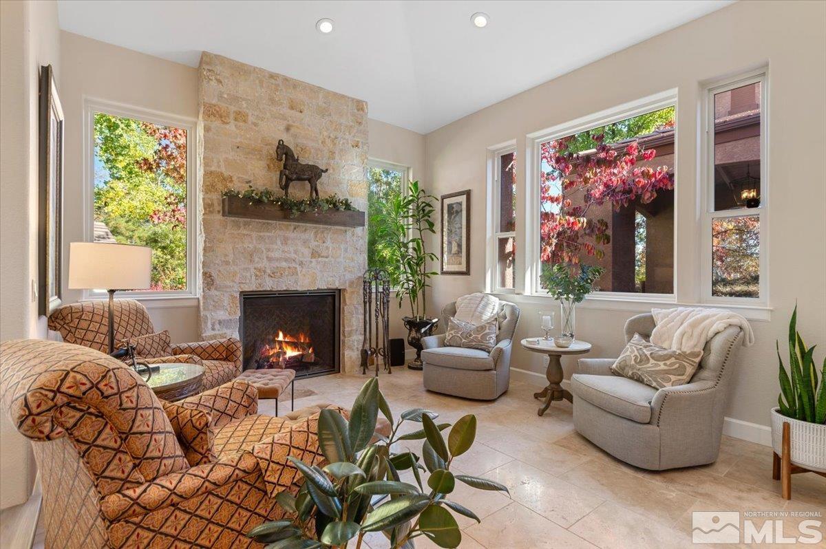 14235 Powder River Court Reno, NV 89511 - Photo 8 of 40 a living room with furniture large window and a fireplace