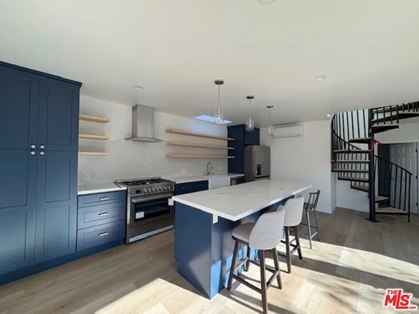 a kitchen that has a table and chairs in it