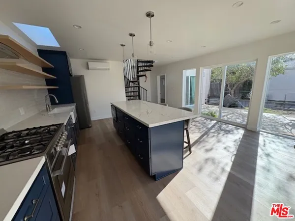 a kitchen with a stove and a refrigerator