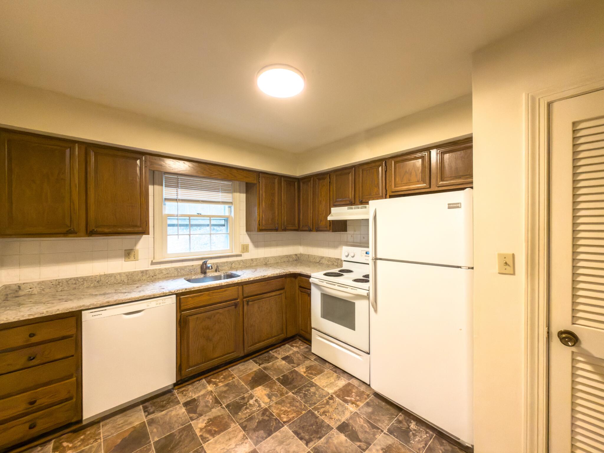 847 King James Street Southwest, Unit A Roanoke, VA 24014 - Photo 4 of 9 a kitchen with a sink a refrigerator and cabinets