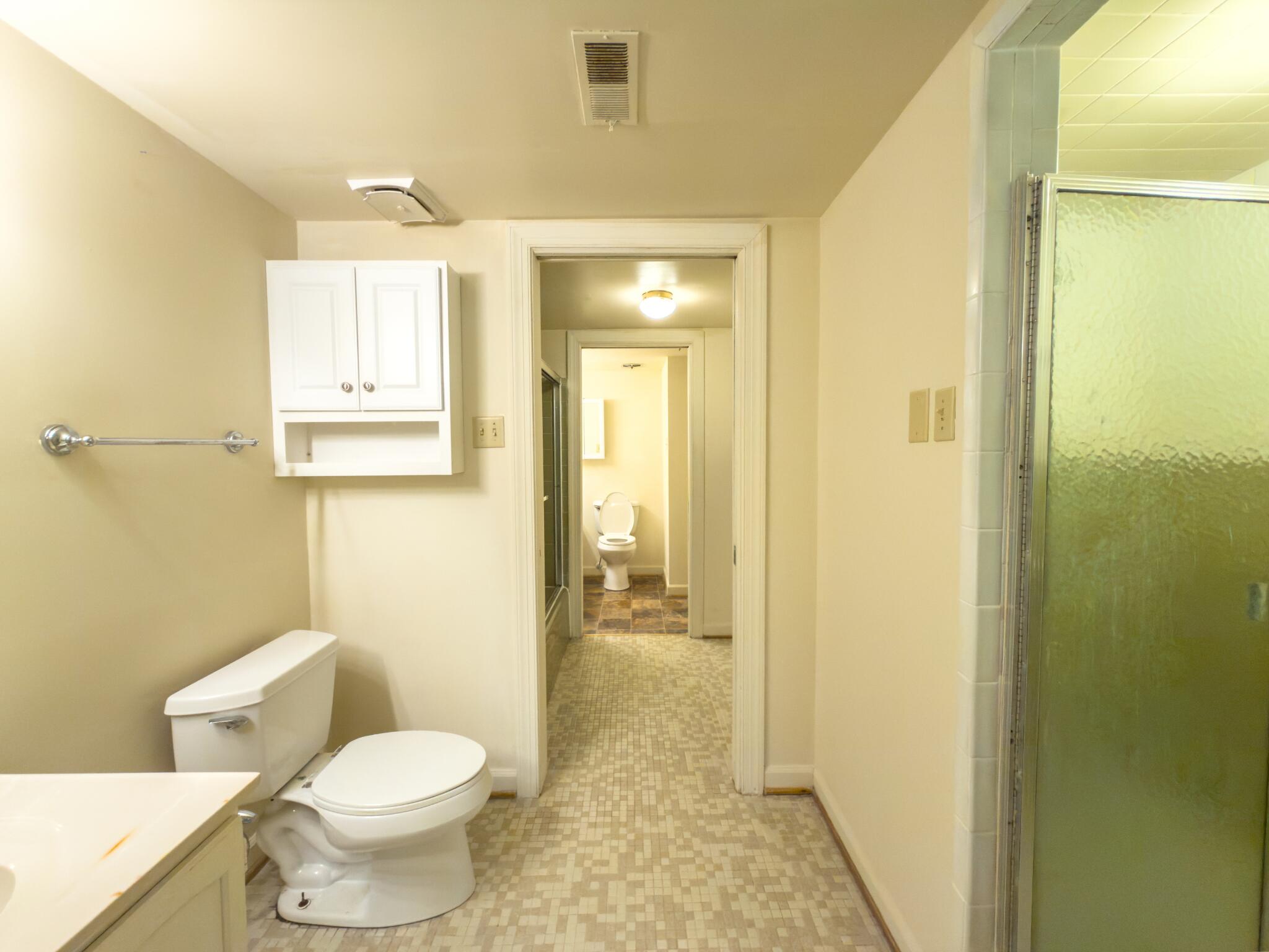 847 King James Street Southwest, Unit A Roanoke, VA 24014 - Photo 8 of 9 a bathroom with a granite countertop toilet and a sink