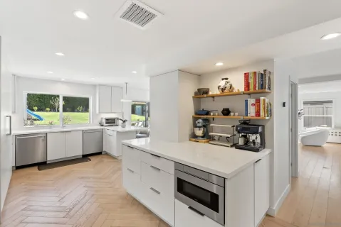 a spacious bedroom with a bed and a cabinets