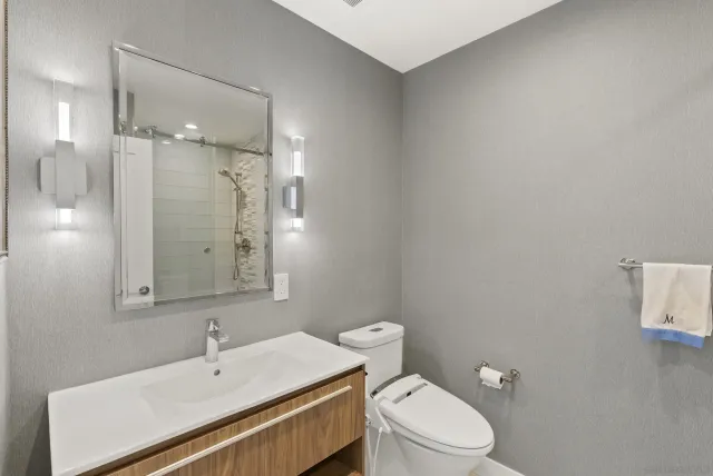 a bathroom with a tub sink and mirror