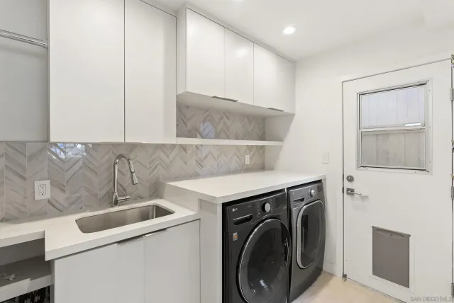 a view of a patio with table and chairs with wooden fence