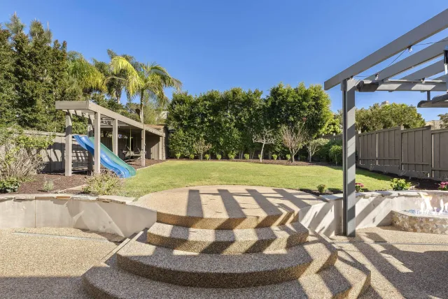 a view of a house with backyard porch and sitting area