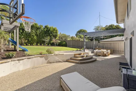 a view of a house with furniture and garden