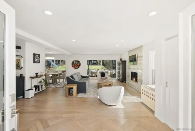 a living room with fireplace furniture and a table