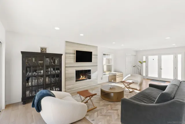 a living room with furniture a flat screen tv and a fireplace