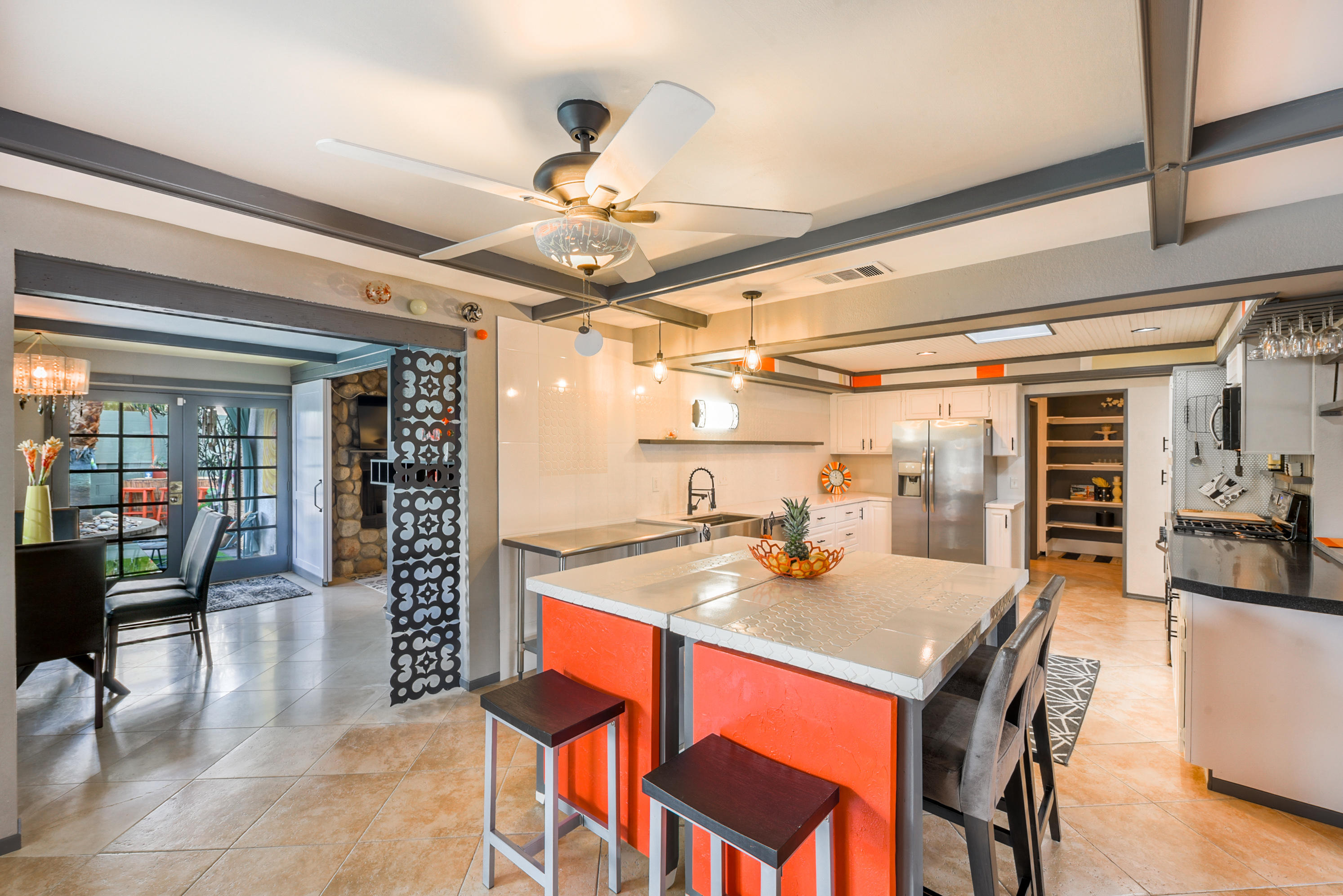 2306 Acacia Road East Palm Springs, CA 92262 - Photo 13 of 37 a kitchen with a dining table and chairs with wooden floor