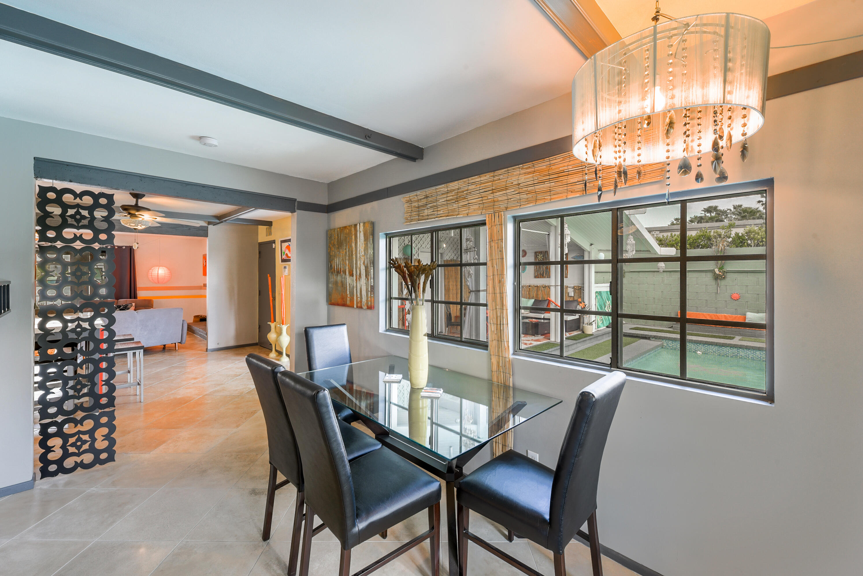 2306 Acacia Road East Palm Springs, CA 92262 - Photo 14 of 37 a view of a dining room with furniture large windows and wooden floor
