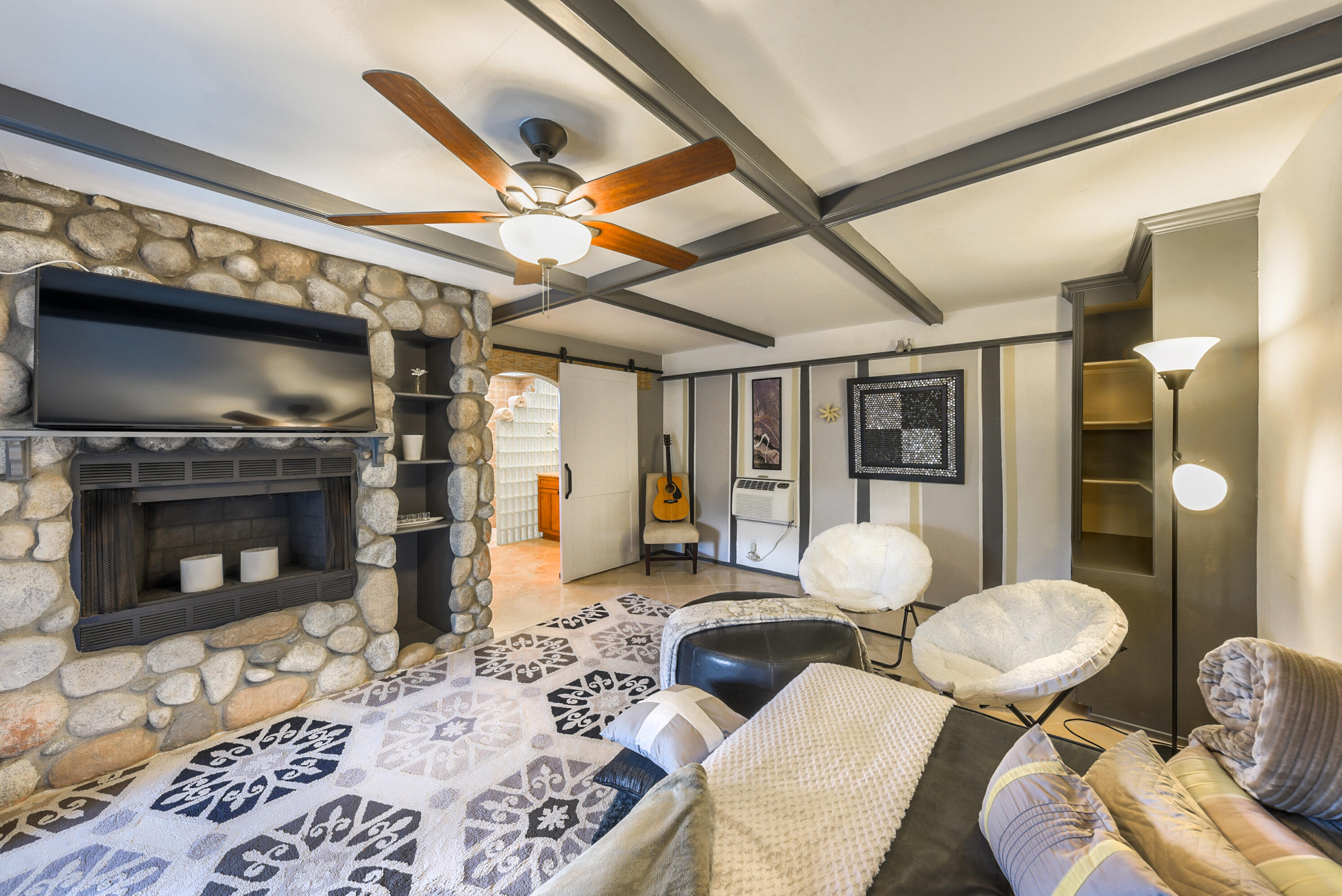 2306 Acacia Road East Palm Springs, CA 92262 - Photo 15 of 37 a living room with furniture a flat screen tv and a fireplace