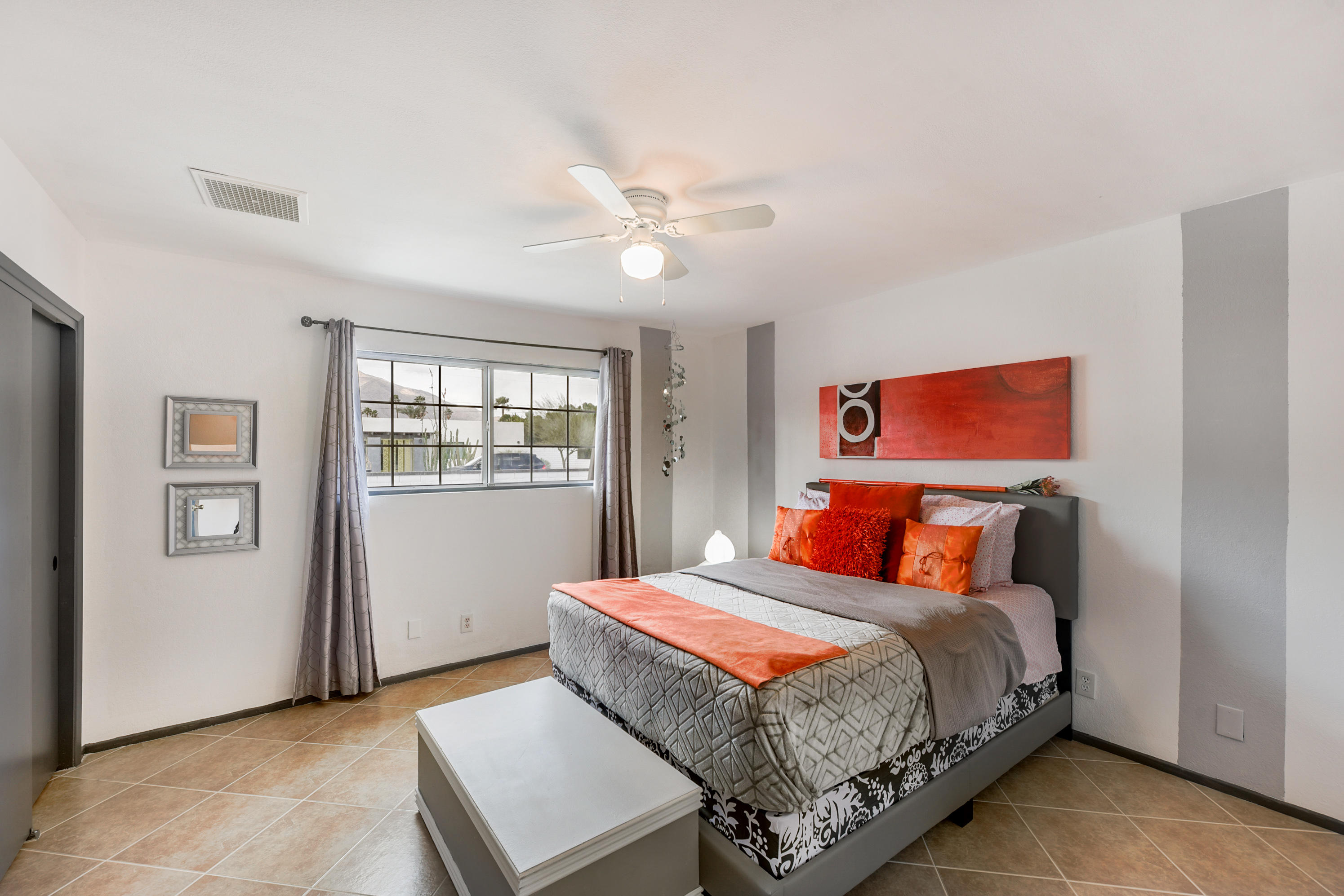 2306 Acacia Road East Palm Springs, CA 92262 - Photo 19 of 37 a bedroom with a large bed and a chandelier