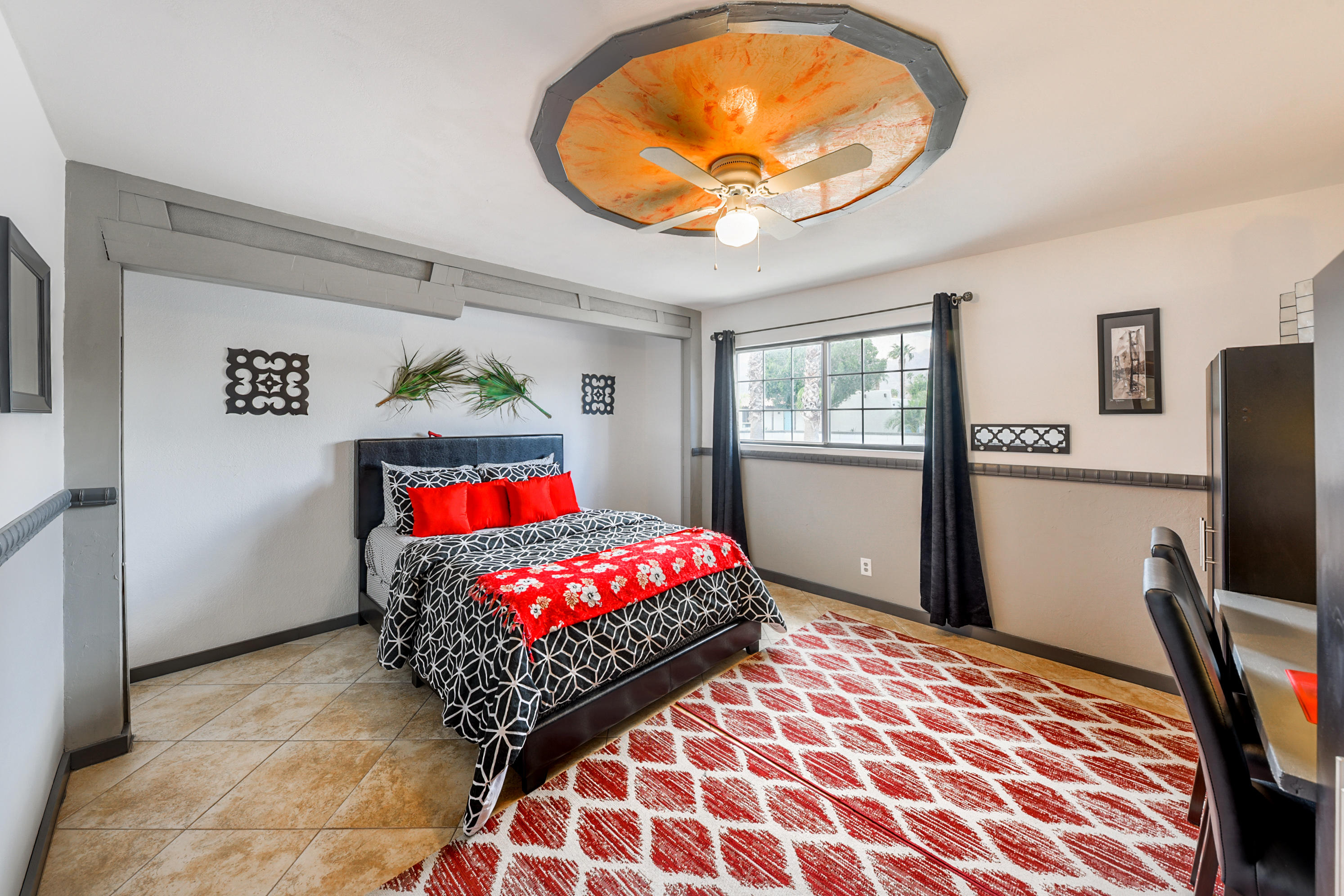 2306 Acacia Road East Palm Springs, CA 92262 - Photo 22 of 37 a bedroom with a bed and a painting on the wall